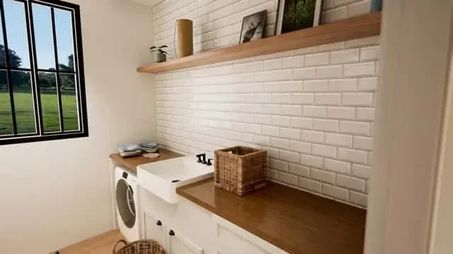 Plan 51942HZ laundry room with stacked Electrolux front-load washer and dryer custom cabinetry folding counter in Caesarstone Snow Corian sink and walk-through to primary closet