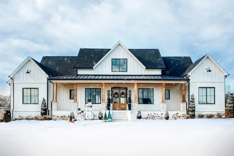 Plan 56478SM seasonal exterior render showing the symmetrical modern farmhouse facade in winter conditions, useful for buyers in Asheville and mountain markets evaluating snow-load roofline