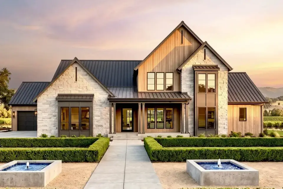 Front exterior of the transitional farmhouse with stone veneer, horizontal siding, and dark standing-seam metal roof