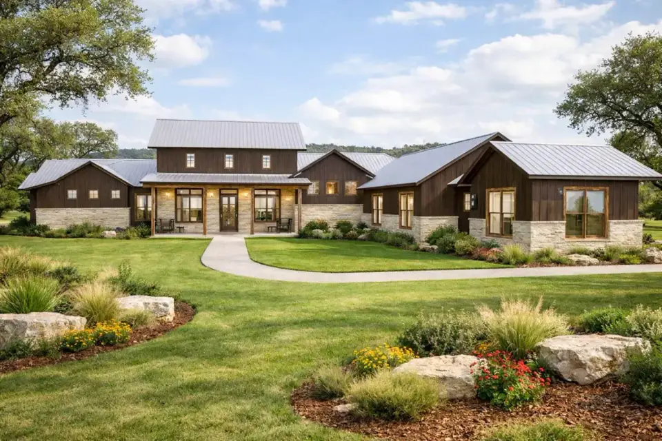 Front elevation of 3,514 sq ft Hill Country modern farmhouse with steeply pitched dark metal roof, dark vertical siding, stone veneer base, and timber porch posts
