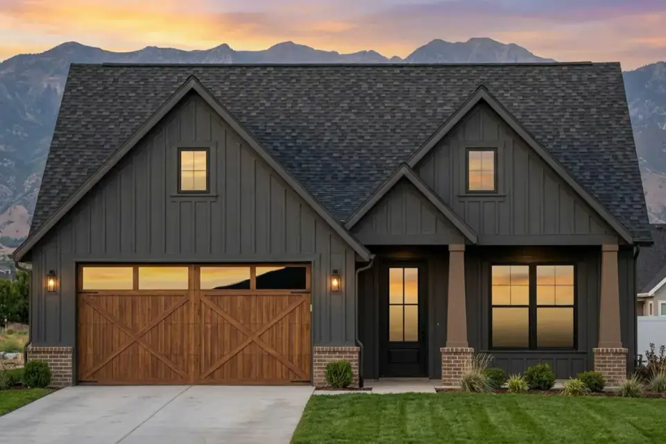 Front elevation of the 1,601 sq ft modern farmhouse cottage with three prominent front-facing gables, board-and-batten siding mixed with stone veneer base, timber porch columns, multi-pane windows flanking the front door, and wood-look garage door