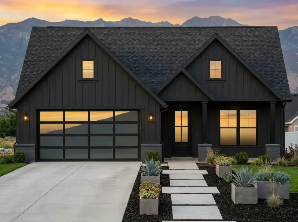 Monochrome bold facade variation with dark charcoal vertical board-and-batten siding, black trim, black-framed glass garage door, dark grey stone base, geometric concrete planters with agave plantings, black mulch, and large concrete pavers