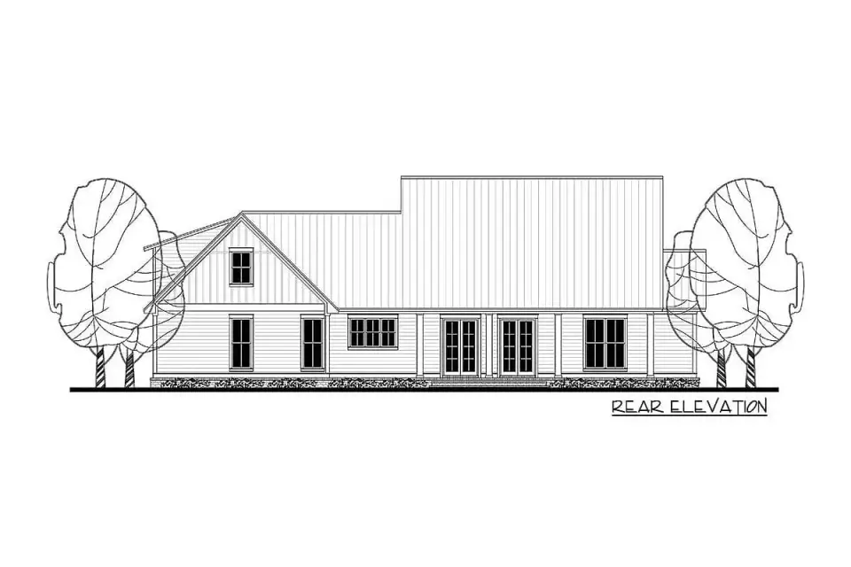Wide landscape view setting the house against open meadow with gravel driveway and mature oak framing