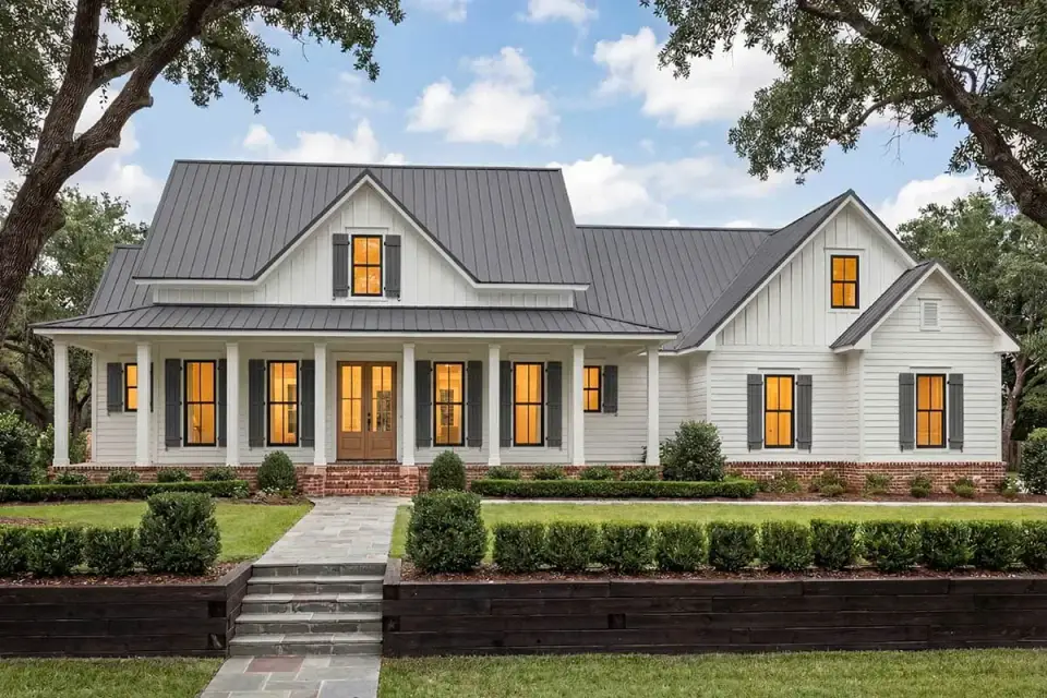 Side elevation showing the 3-car side-load garage wing and rear covered porch integration