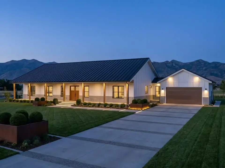 Contemporary lit farmhouse facade of plan 35145GH with white board and batten and landscape lighting