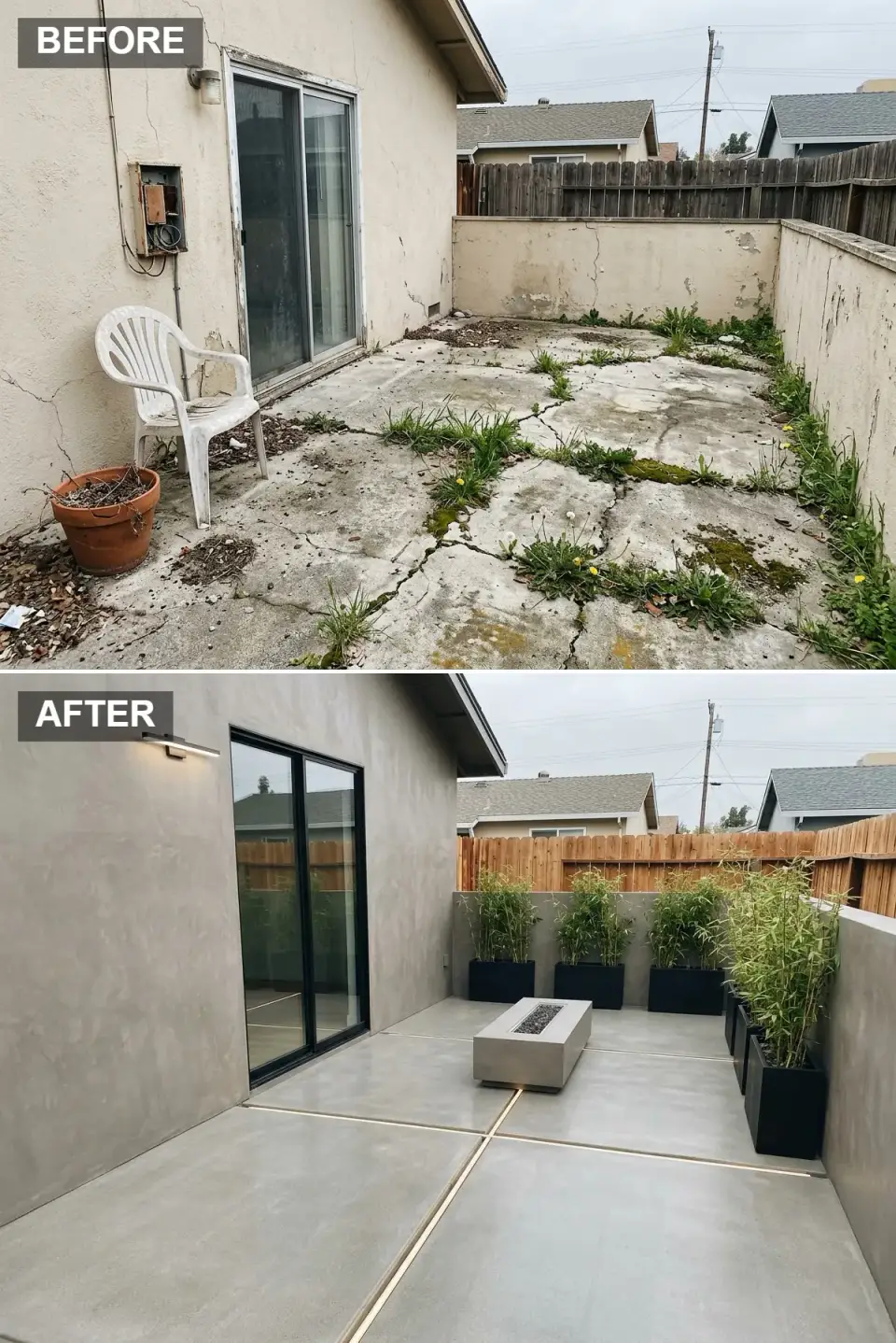 Moody minimalist atrium with gray microcement walls, large-format concrete tile flooring, embedded LED strip lighting in expansion joints, low rectangular concrete fire pit, black rectangular planters with tall bamboo, black-framed sliding door, linear LED wall sconce