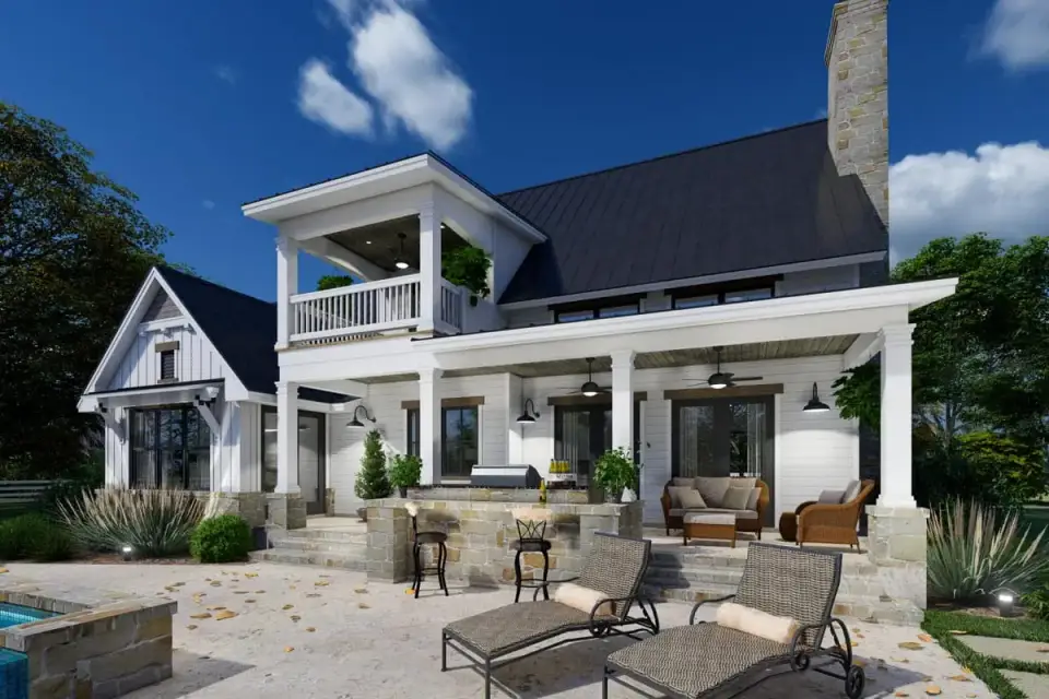 Dusk elevation of Plan 16919WG with warm interior lighting visible through two-story family room windows and covered front veranda with ceiling mounted downlight fixtures