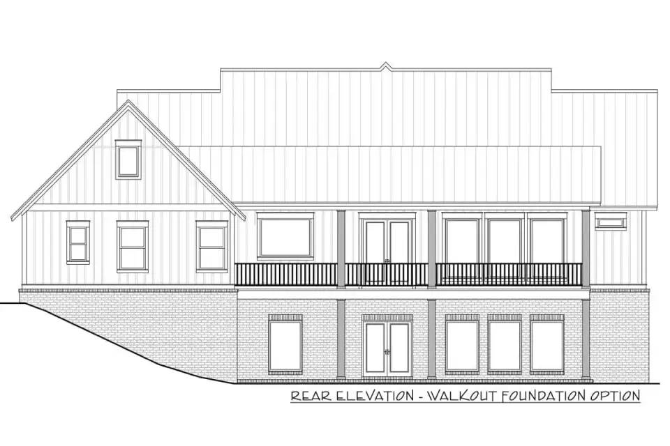 Dusk view of Plan 51814HZ showing the walkout basement foundation option with lower-level windows and a rear terrace extending from the main covered porch above