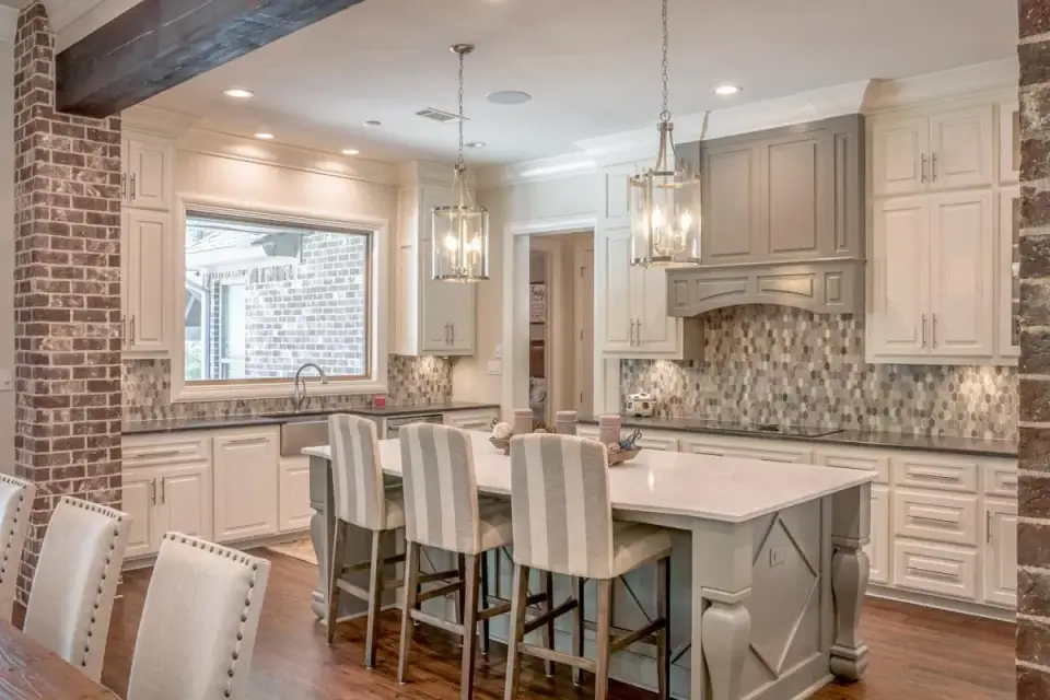 Kitchen island detail of Plan 51814HZ showing the 10-foot Caesarstone 4121 Apple Martini island with waterfall edge, shiplap hood treatment, and Wolf cooktop