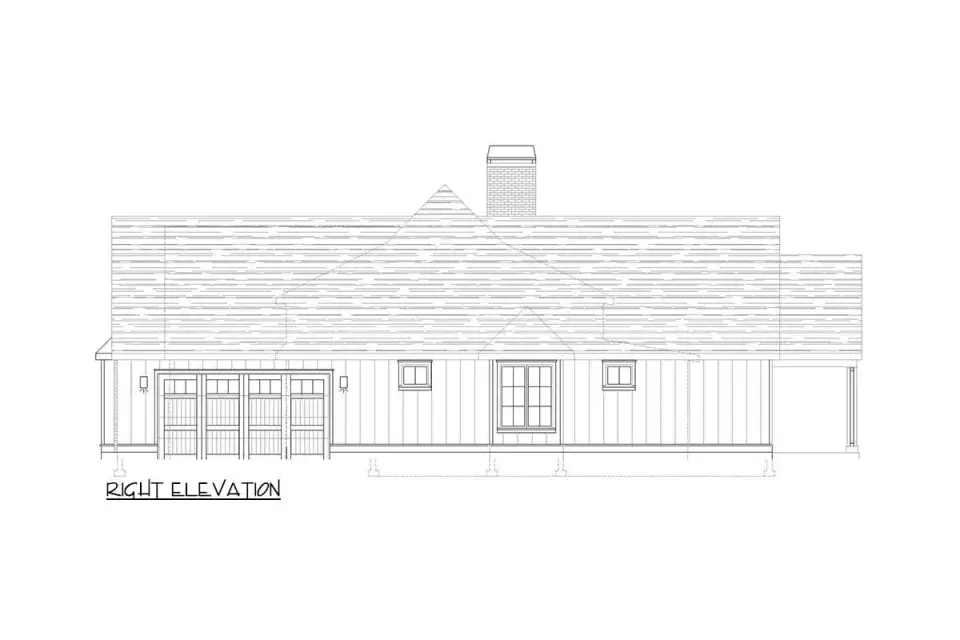 French country house plan twilight elevation with warm landscape lighting