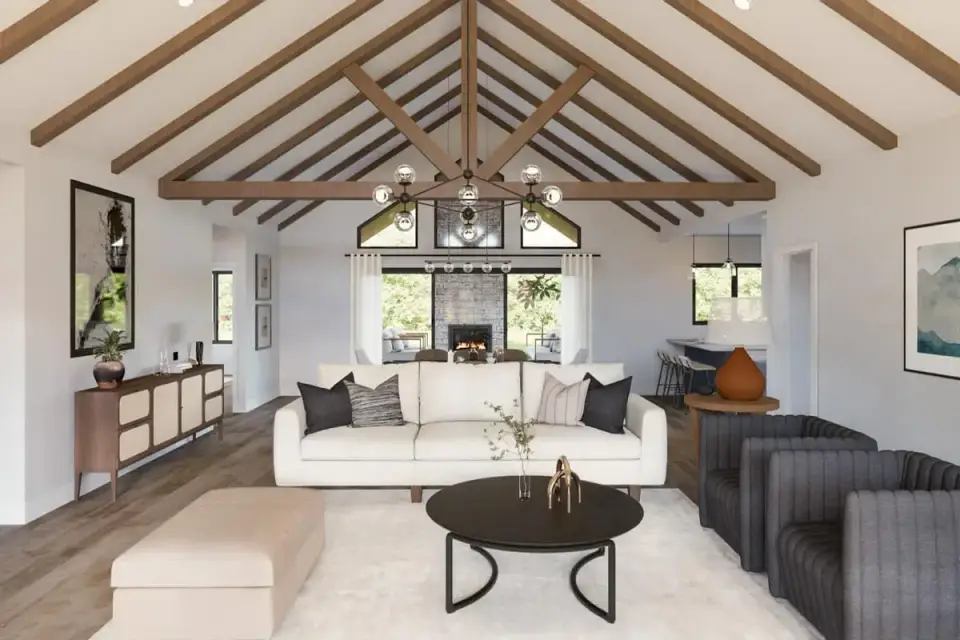 Great room interior with vaulted ceiling, exposed wood beams, stone-clad fireplace focal wall, and sliding glass doors opening to the rear covered porch