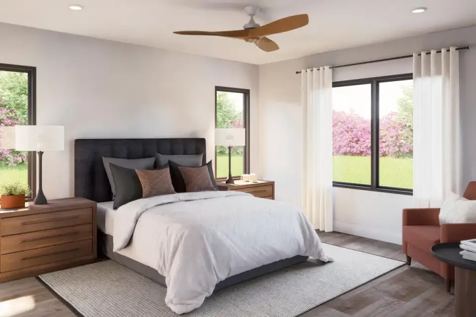 Primary bedroom with tray or sloped ceiling, large window, and door leading to the five-fixture en-suite bathroom