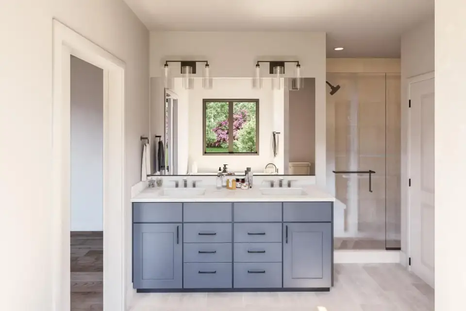 Laundry room with side-by-side washer and dryer, folding counter, upper cabinets, and entry from the primary closet