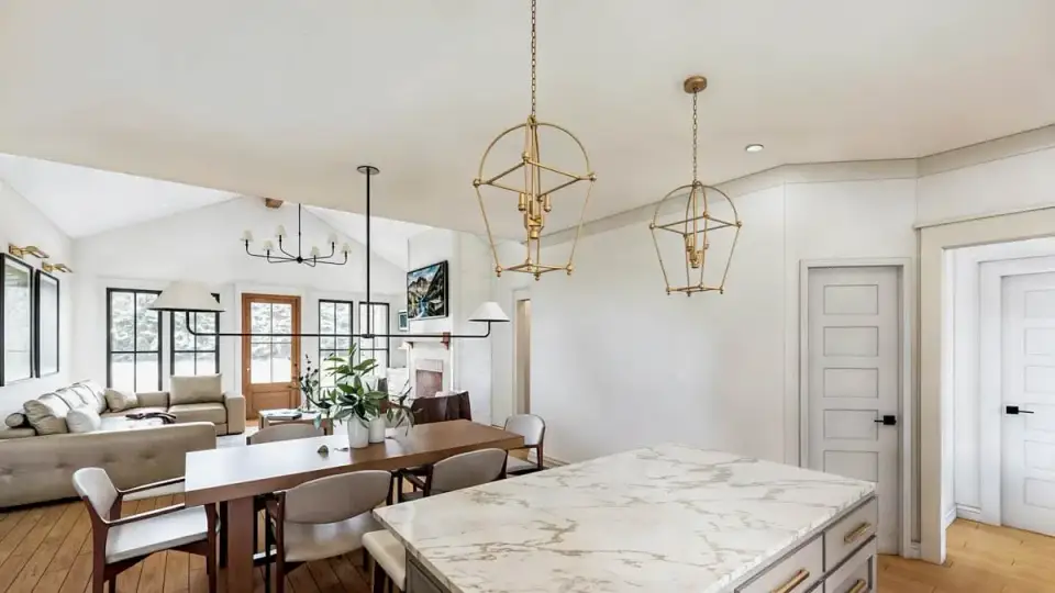 Dining area adjacent to kitchen island with farmhouse table seating