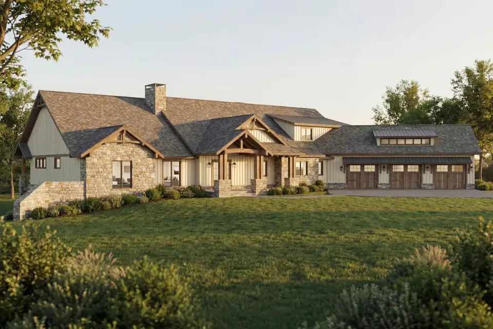 Rear elevation of plan 70966MK with the vaulted outdoor living porch, stone arches of the walk-out lower level and lower garage doors