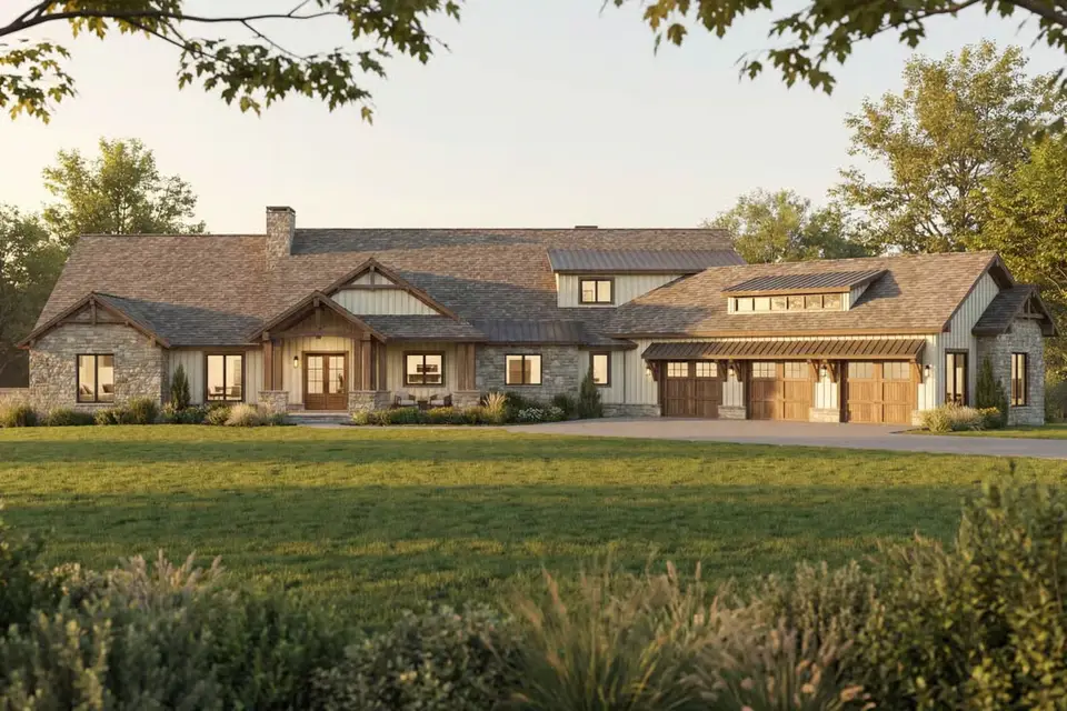 Front elevation of luxury mountain house plan 70966MK with stone bases, cream board-and-batten siding, timber gable brackets and 3-bay garage