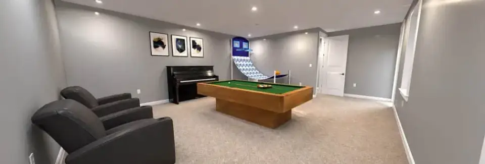 Great room with 15-foot ceiling, light wood flooring, and gray walls