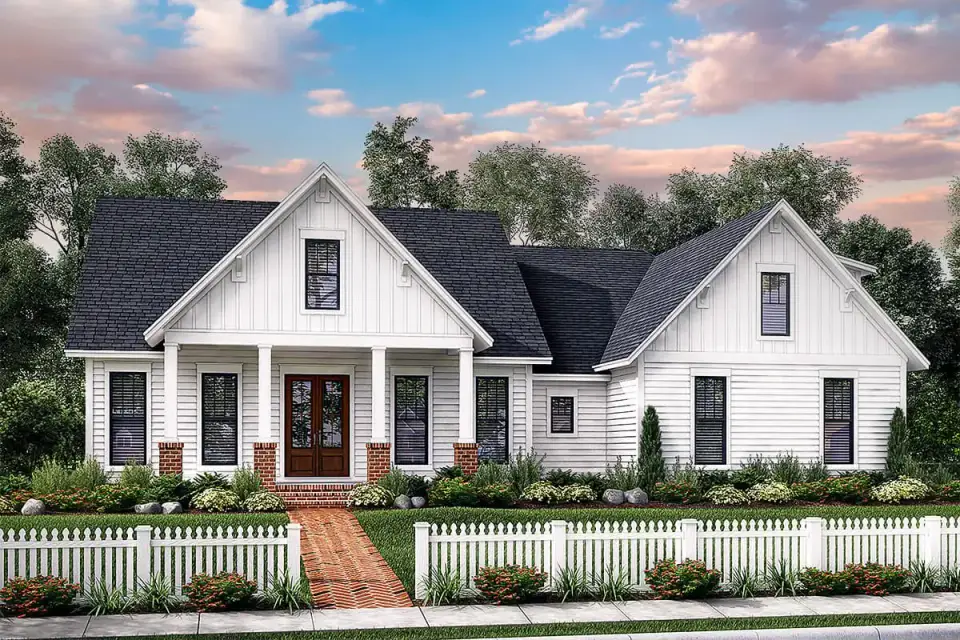 Front porch detail showing the brick pier bases, white columns, standing-seam metal roof, and deep porch overhang