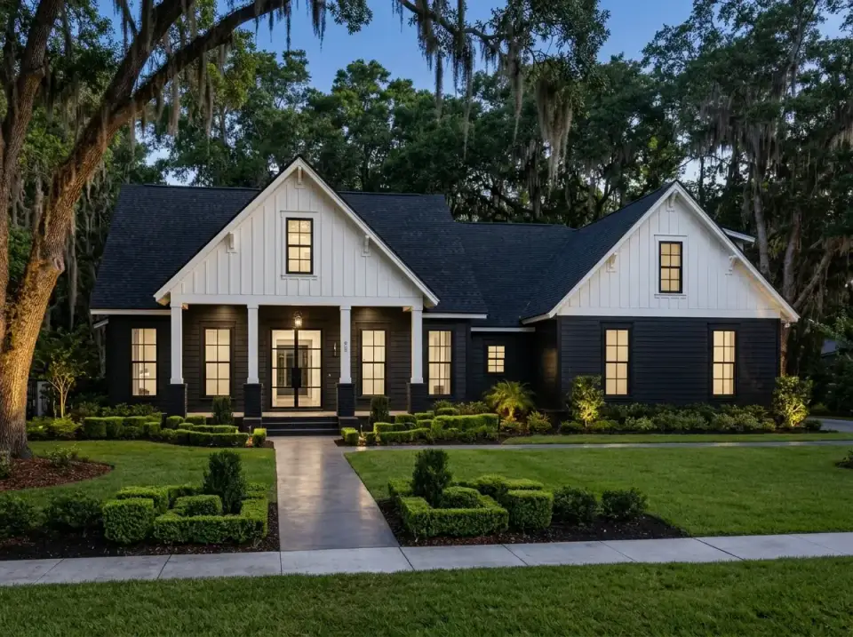 Stark modern variation with dark siding, black metal roof, crisp white trim, and formal minimalist landscaping using clipped boxwoods