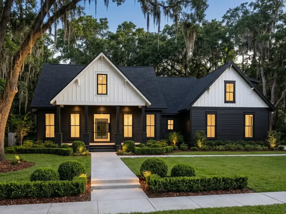 Bold Craftsman variation with black vertical siding, white gable trim, dark shingle roof, white picket fence, and lush green lawn