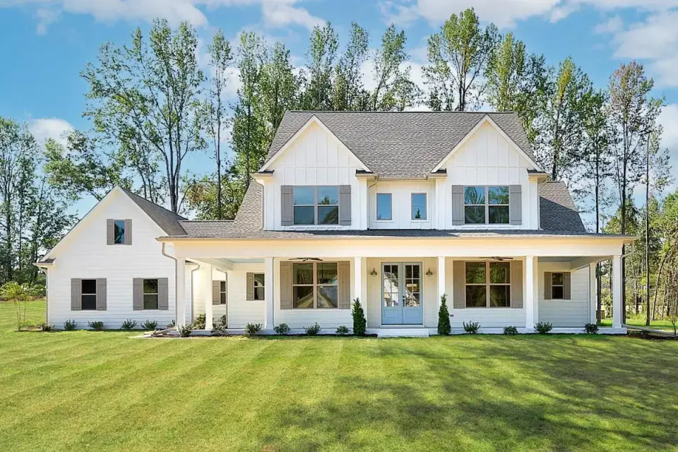 Plan 4122WM front elevation with cross-gable roof board-and-batten siding stone veneer foundation wrap-around porch