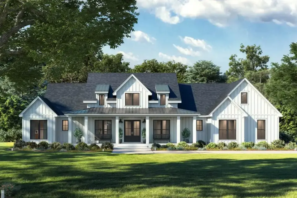 Front elevation of modern farmhouse 52021HZ showing prominent board-and-batten gables, metal roof accents over the front porch and dormers, timber columns, and a clean side-entry garage configuration