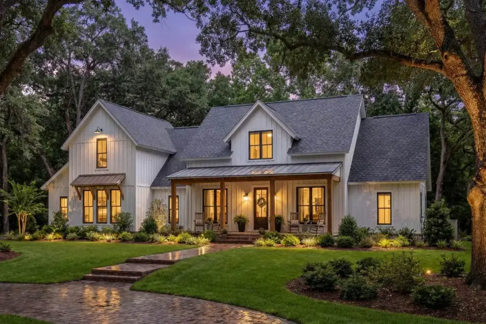Evening rendering of modern farmhouse 51773HZ with warm window lighting and porch ceiling fans