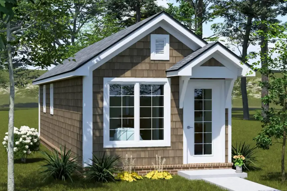 Plan 52530WM front exterior elevation showing ranch-inspired one-bedroom cottage with side-gable roof projecting gabled entry porch shingle siding brick water table and white trim