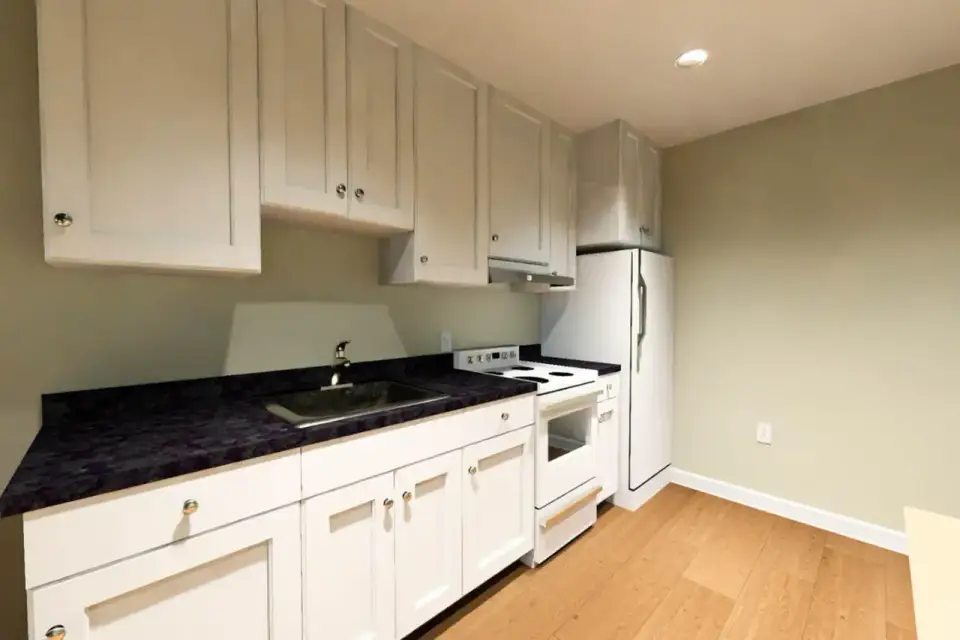 Plan 52530WM bedroom with 8 foot ceiling neutral walls and direct access to the bathroom at the rear of the cottage