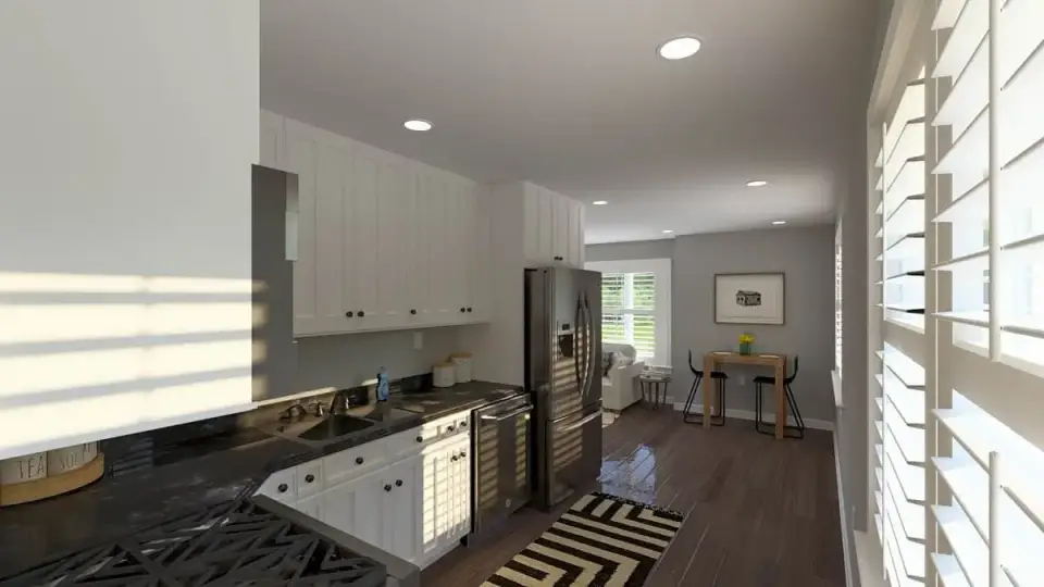 ADU upper level kitchen with full-height white cabinetry, dark quartz counters, and stainless appliances