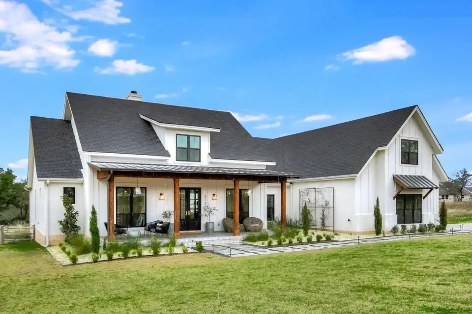 Front porch with timber columns and black framed windows modern farmhouse plan