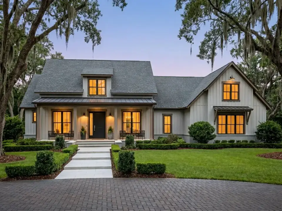 Contemporary grey and white farmhouse facade with geometric paver walkway