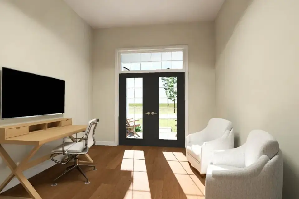 Vaulted living room with neutral walls and rear-facing windows in a ranch house plan
