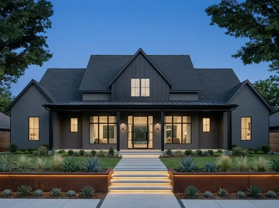 Plan 56549SM facade variation 6 — matte charcoal grey siding, trim, and metal roof throughout, large black-framed windows, massive glass pivot front door, weathered Corten steel retaining walls, integrated step lighting, sculptural agave and grass plantings