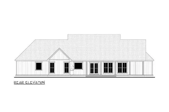 Daylight front view showing the driveway approach, landscaping, and the proportional relationship of gables and porch to the overall mass