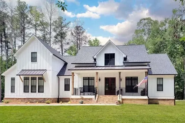 Three-quarter front rendering showing timber porch columns and metal gable accents
